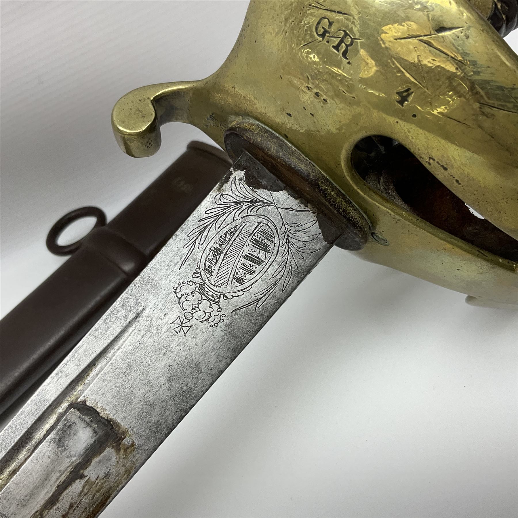 19th Century German (Saxony) Cavalry Sword, the 90.5cm single edge curved steel blade with narrow fuller to the back edge at each side, engraved with a crowned AR monogram and coat of arms, stamped with crowned AR, the back edge engraved C.v Keller im Solingen 1862, the brass half basket hilt with three flat curved bars, applied badge missing, marked G.R. 4, with ribbed leather covered grip and leather finger strap; in steel scabbard with two fixed suspension rings to one side and stamped G.R. II 118; L109.5cm overall