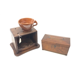 A 19th century mahogany tea caddy, of sarcophagus form and raised upon four compressed bun feet, the hinged cover opening to reveal a twin compartmented interior, L24.5cm, together with an Antique Dutch oak foot warmer, with pottery cinder bowl, H19.5cm.