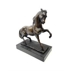 Bronze figure modelled as a prancing horse, upon a naturalistically modelled rectangular base, and black marble plinth, H34.5cm, W16cm, L32cm
