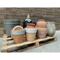 A quantity of various terracotta and glazed planters