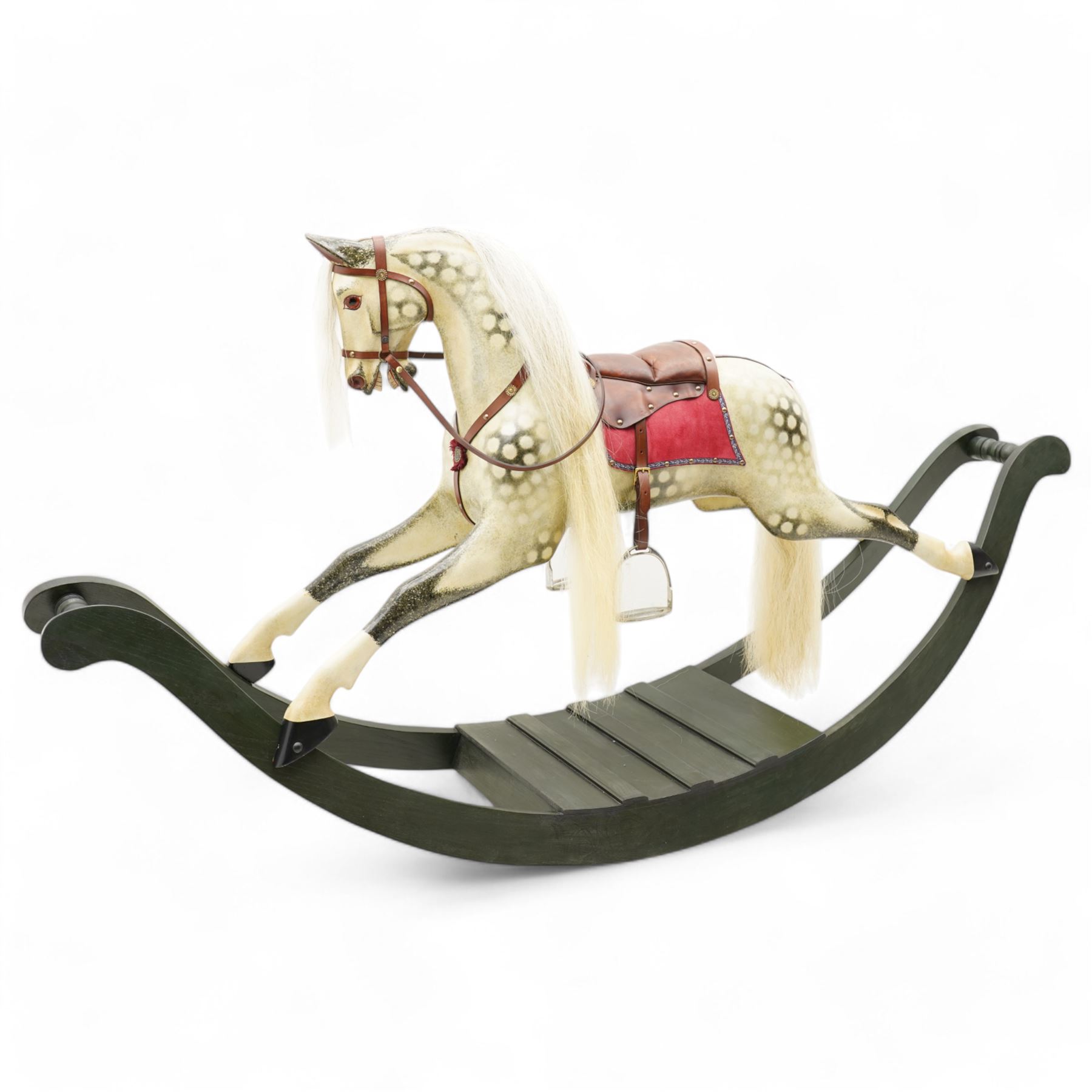 In the manner of F. H. Ayres - large carved wooden rocking horse, in dapple grey paint finish, decorated with glass eyes, leather reins, stirrup and saddle, on bowed rockers united by turned stretchers and boarded base 