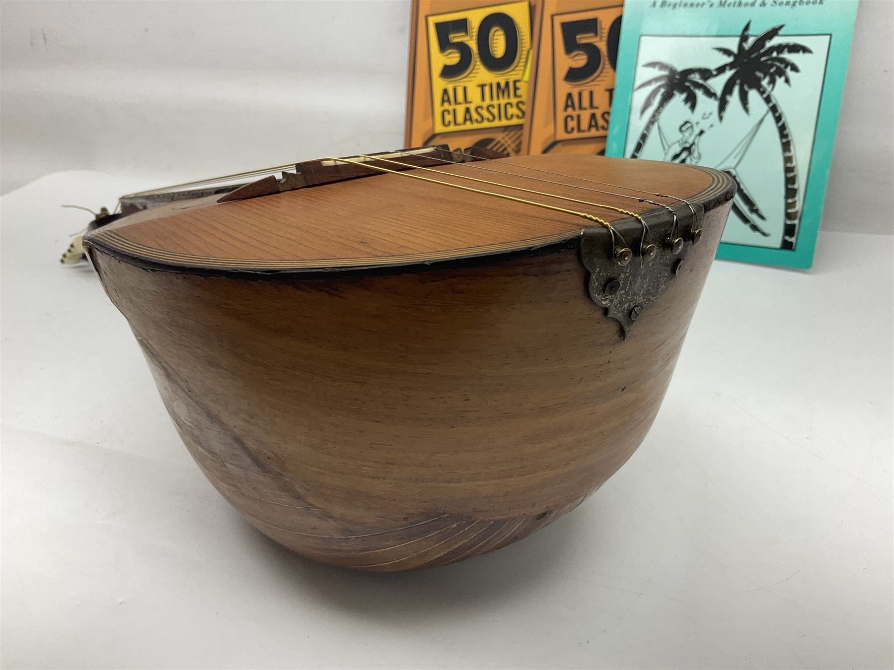 W.D. Keech banjolele pat.219720/23 with etched signature to the back; serial no.A12082 L55cm; and a restored Italian mandolin with segmented lute back; together with three music books