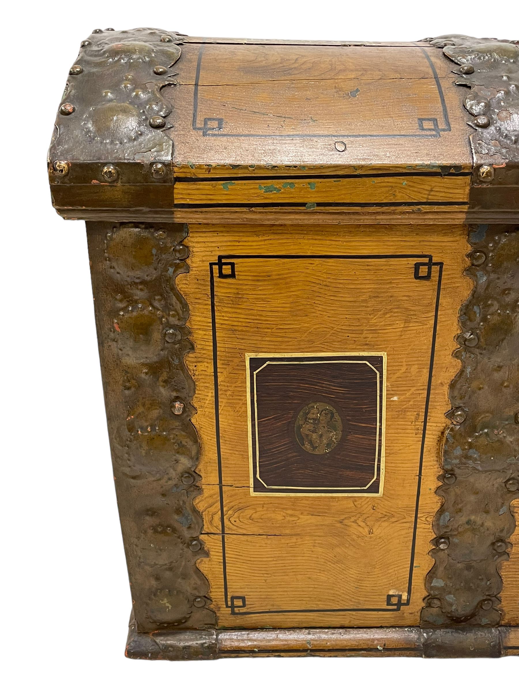 19th century painted oak sea chest, hinged dome top enclosing small compartment, bound by shaped and pressed metal strapwork, scumbled finish to resemble oak and painted with small vignettes depicting portraits and landscapes within panels, fitted with large wrought metal carrying handles, the front inscribed 'H.J.S. 1870' 