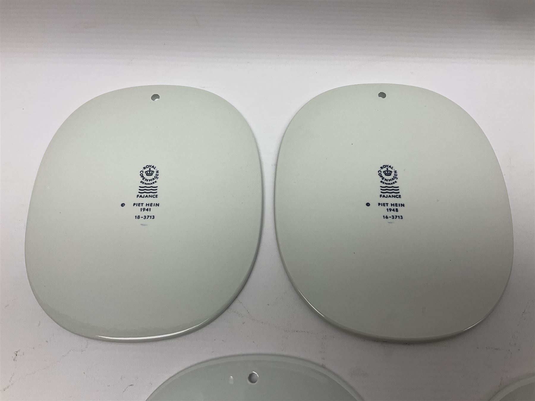 Seven Royal Copenhagen Piet Hein 1948-1980 plaques,all with printed mark to back H17cm