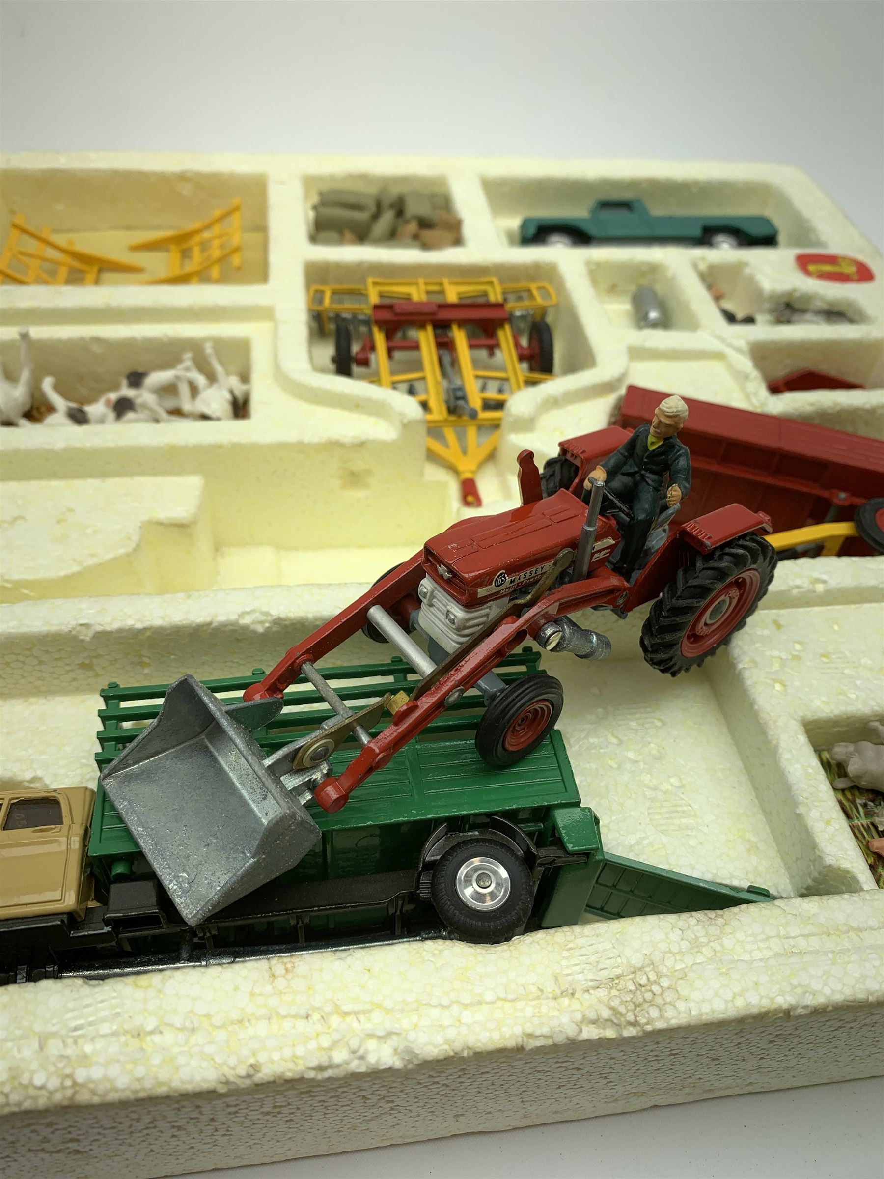 Corgi Toys Agricultural Gift Set No.5 containing Massey-Ferguson 165 Tractor with shovel and skip and churns attachment with two churns, Tandem disc harrow, farm tipper trailer with raves, Land Rover, Dodge Kew Fargo truck with four cattle and four pigs, farm worker and dog,  eleven large sacks and five small sacks, boxed