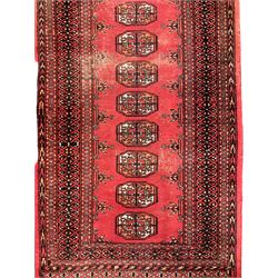 Persian Bokhara red round runner, the field decorated with single row of Gul motifs, geometric design repeating border