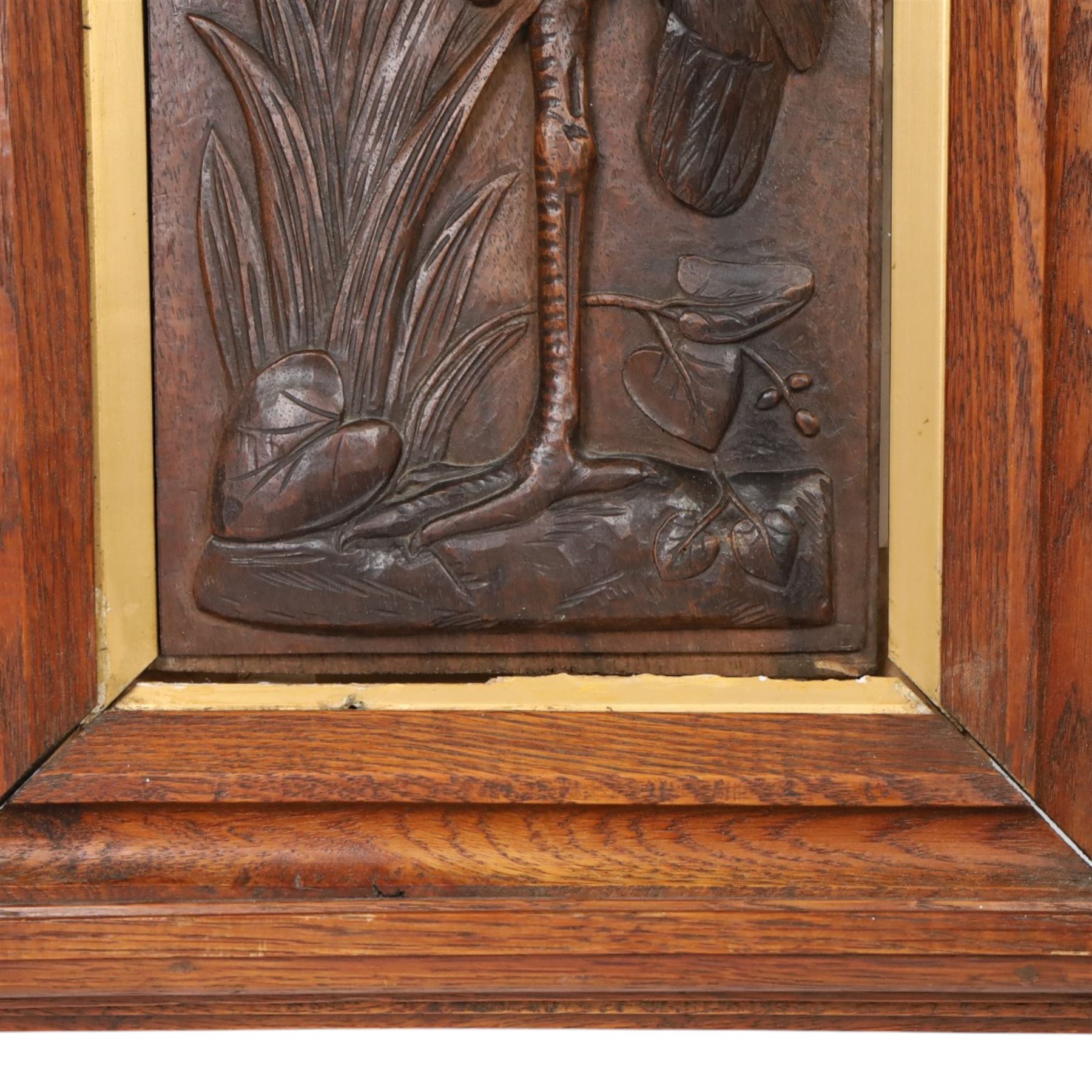 After Leander Plummer II, carved wooden panel of a stork amongst reeds, within a wooden frame, H80cm