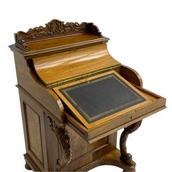 Fine and unusual 19th century olivewood piano top davenport, raised shaped back carved with olive branches and olives, the top hinges to reveal lidded and correspondence compartments, the piano lid enclosing sliding top with hinged and adjustable writing surface with leather inset, right-hand panelled door enclosing four drawers, olive branch and scroll carved cabriole front supports on moulded and shaped platform, turned cup feet with recessed castors 