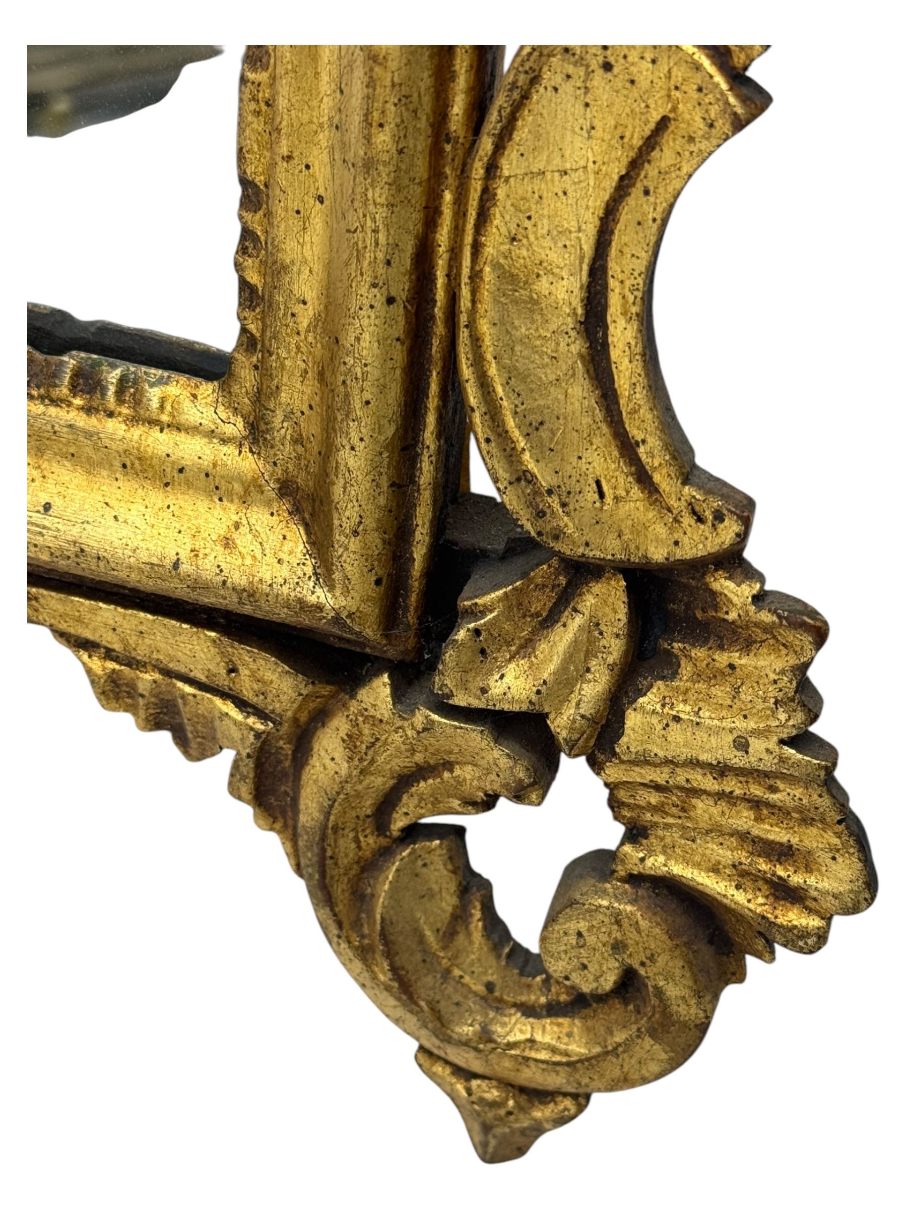 18th century design gilt framed wall mirror, within a pierced and scrolling foliate frame, leaf sprays and flowerhead cresting