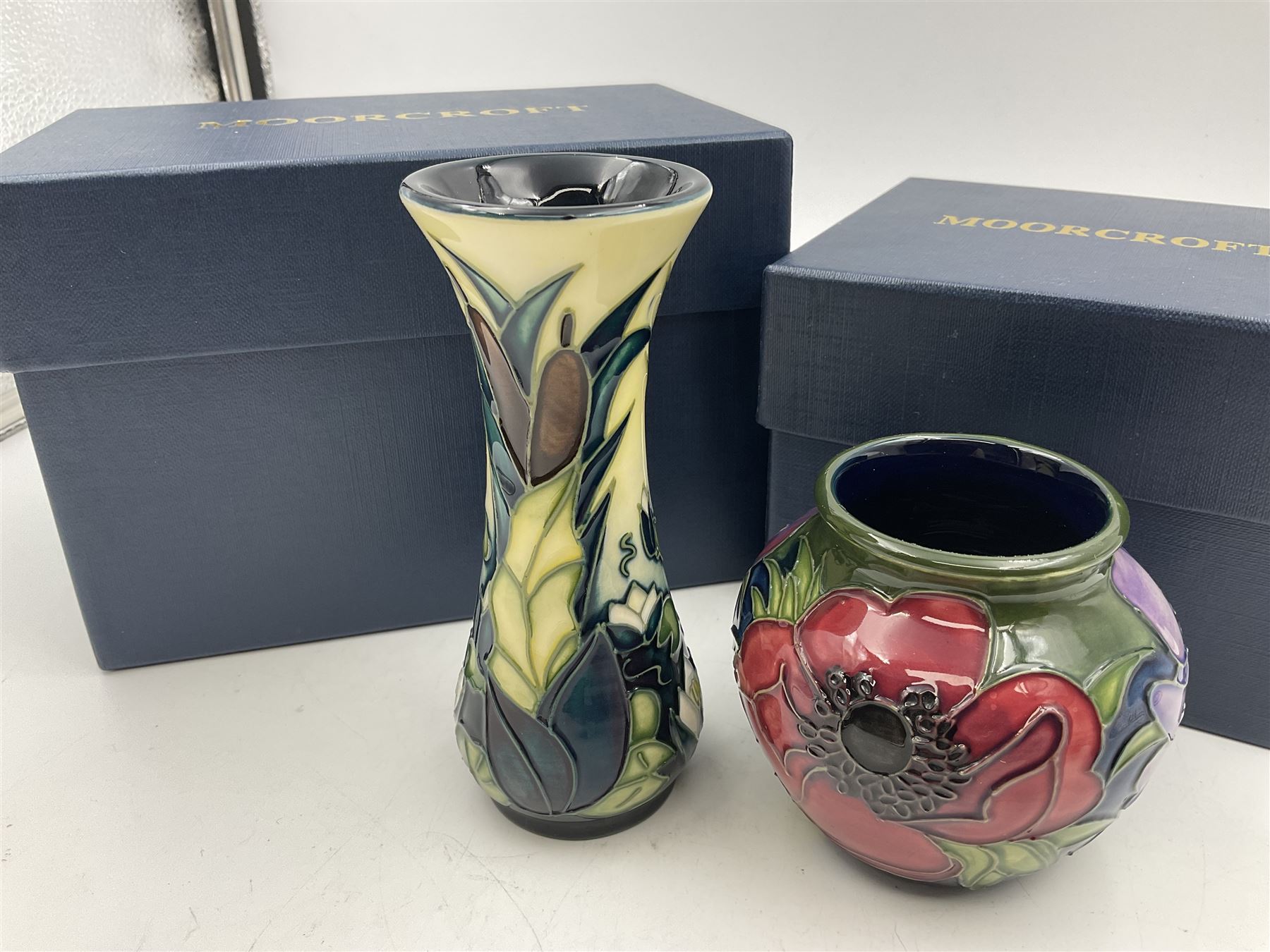 Two small Moorcroft vases, one decorated in the Lamia pattern by Rachel Bison, circa 1995, H13cm and the other in the Anemone Tribute pattern by Emma Bossons, circa 2002, H7.5cm, both with original boxes (2)