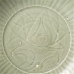 Chinese Ming dynasty Longquan celadon dish, the base carved with a lotus within a ribbed surround D35cm