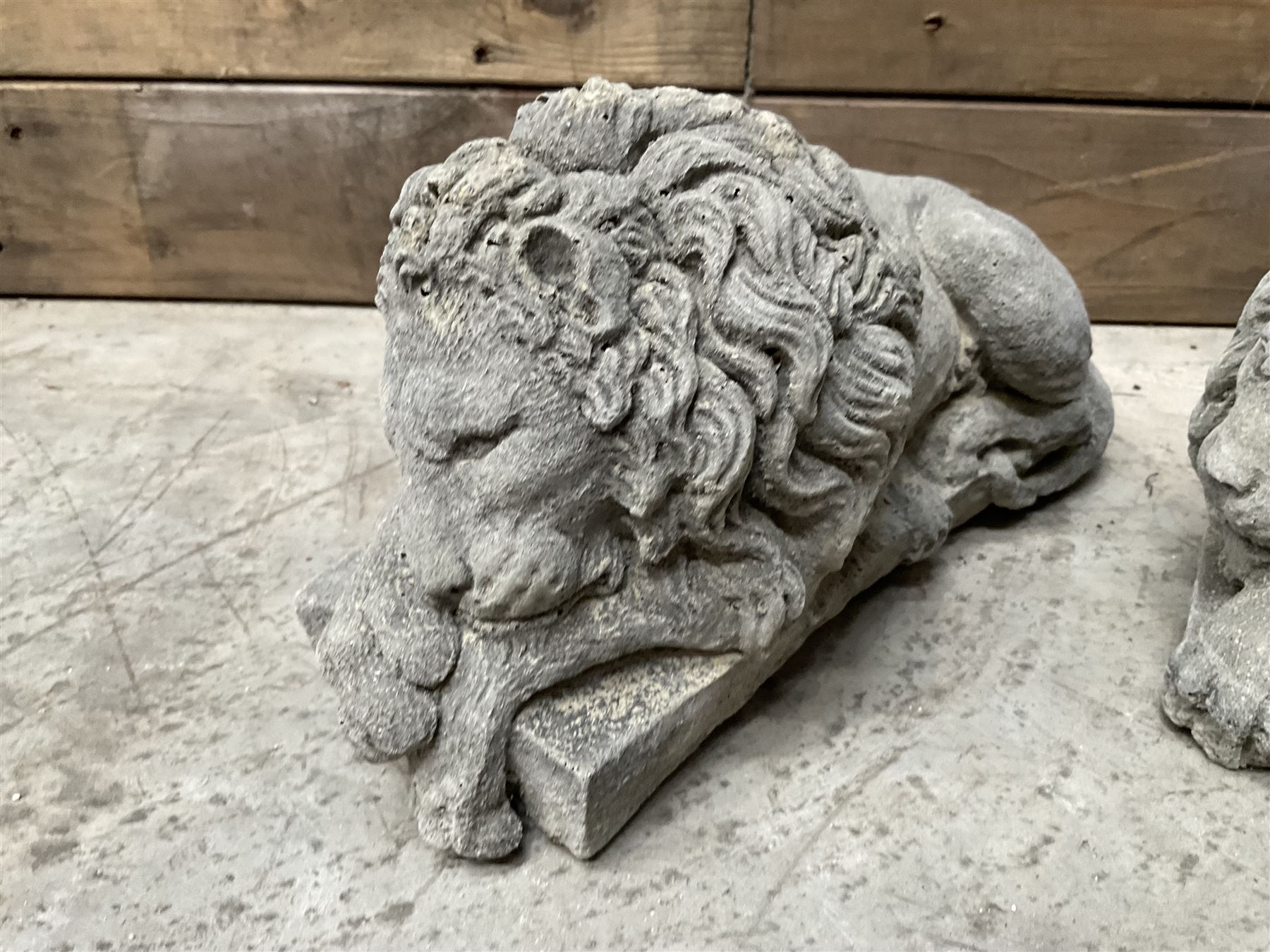 Pair of small cast stone sleeping Trafalgar Lions