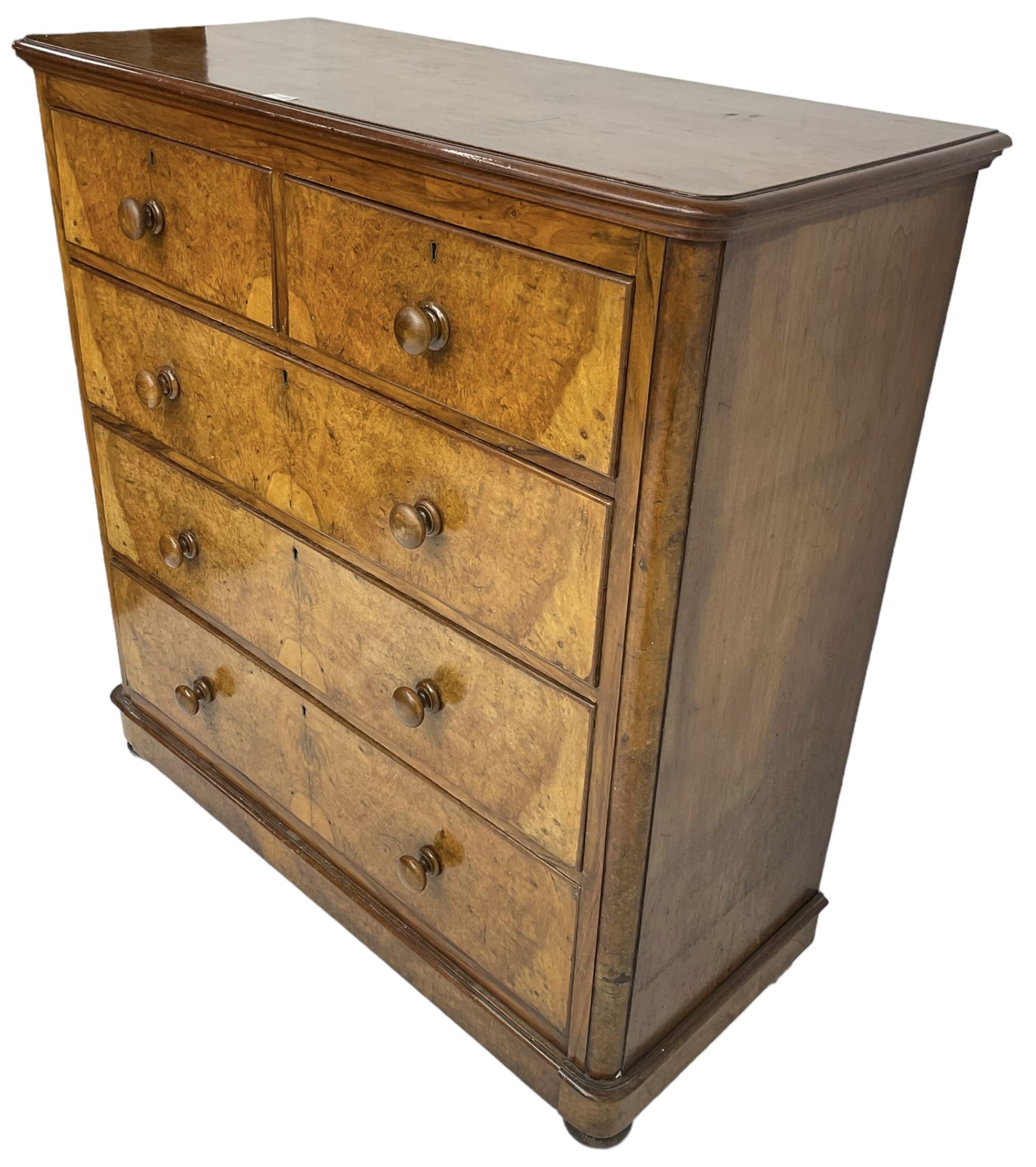 Early 20th century figured walnut chest, fitted with two short over three long drawers with bookmatch veneer facias, each with turned walnut handles, skirted base over compressed bun feet 