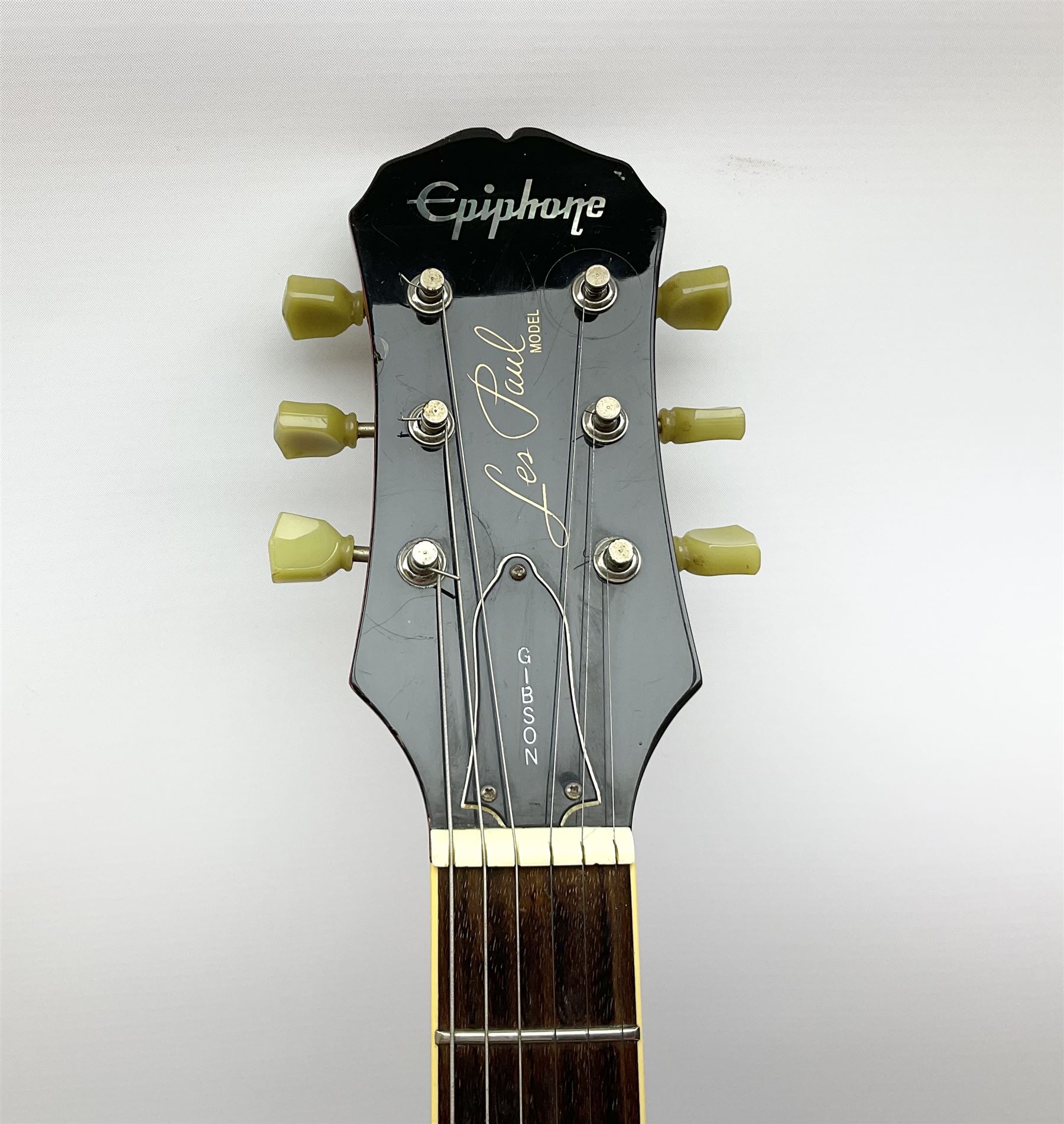 1980s Les Paul Epiphone limited edition cut-away electric guitar by Gibson, the burgundy coloured body with two pick-ups, volume and tone knobs and scratch plate, original tuning pegs, serial no.U6030215, 101cm overall; in modern Kinsman fitted carrying case