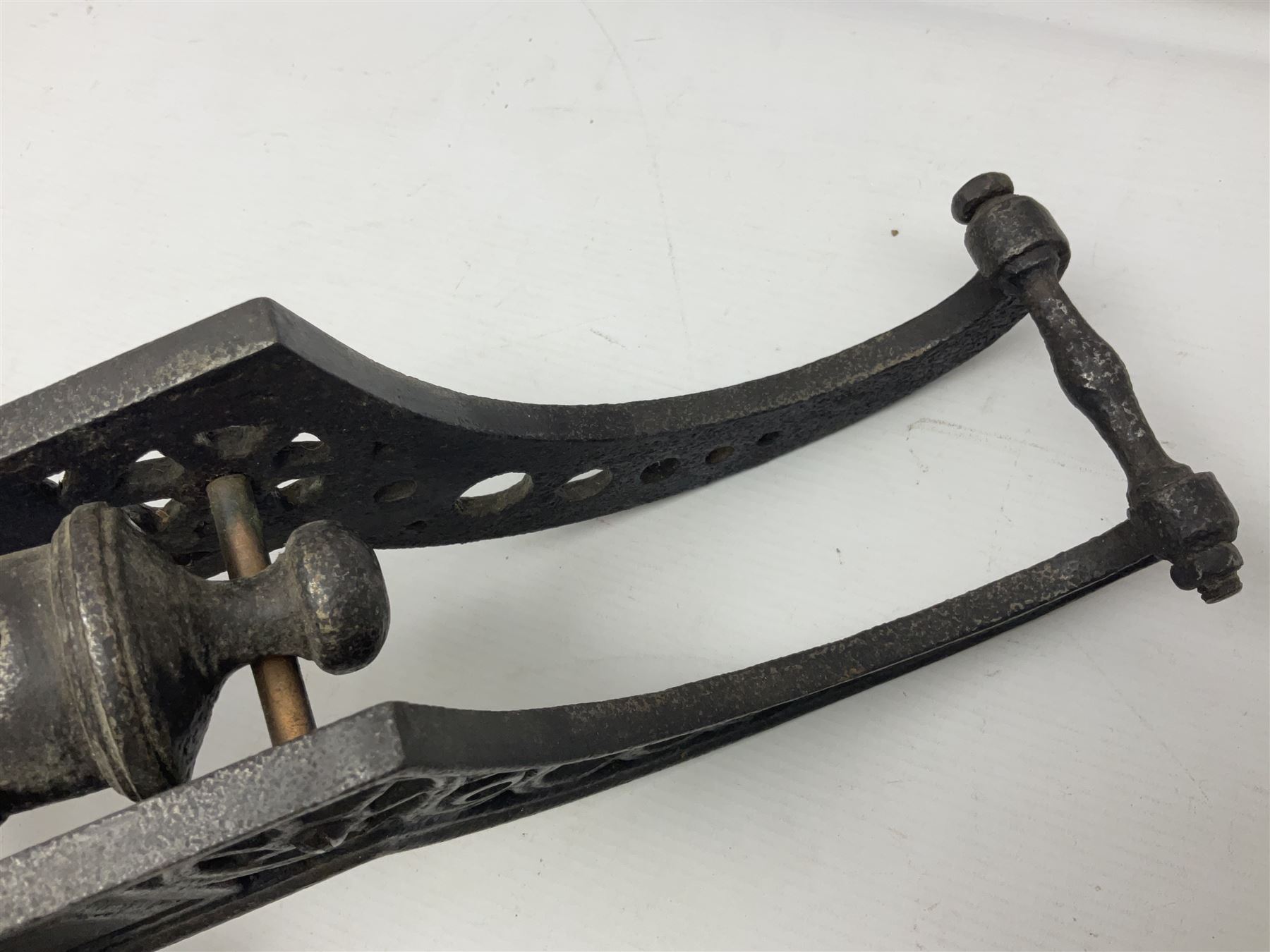 Victorian cast-iron and steel signal cannon, approximately half-inch bore, with 23cm ringed barrel and cylindrical trunnions, on a cast iron carriage with two twelve-spoked wheels and guilloche pierced swept back support, L43cm overall