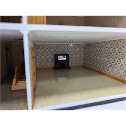 1:24 scale four-storey tudor-style dolls house, with black and white exterior, balcony garden, glazed panelled windows and wooden shingle roof, with decorated interior and wired fireplaces and lighting, H65cm, W58cm, D31cm, 