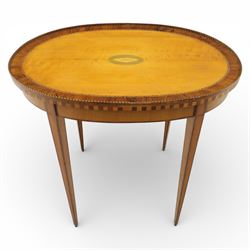 Early 19th century Sheraton revival satinwood oval table, shell motif to the centre bordered by walnut veneer, with inlaid banding, supported on square tapering legs terminating in brass feet