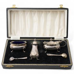 Silver three piece condiment set with shell moulded borders, cased Birmingham 1961/2 Maker Adie Bros