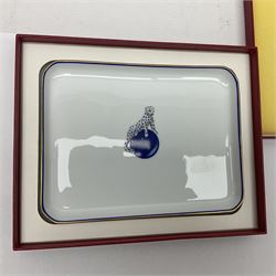 Limoges for Cartier, ceramic trinket dish, of rectangular form with rounded corners, decorated to centre with leopard upon a blue ball, with blue and gilt rim, with printed mark beneath, in original box, H15.5cm, W21cm