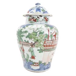 17th century Transitional period Chinese Wucai vase and cover, of baluster form, the body painted with ladies upon a terrace, and figures upon horseback and attendants within a fenced garden, the domed cover with knop finial painted with boys at play, H37cm
