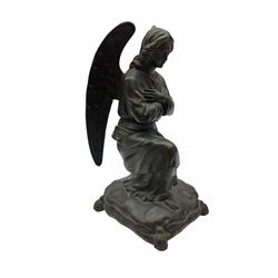 Cast metal figure modelled as a angel kneeling upon a cushion base, H24cm