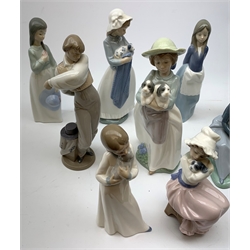 A group of thirteen Nao figurines, together with one Lladro figurine, each with printed mark beneath. 