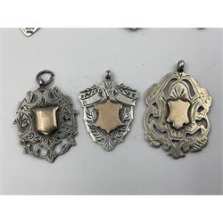 Seven Edwardian and later silver cartouche fobs, to include five gold faced examples and three double sided examples, all hallmarked with various dates and makers
