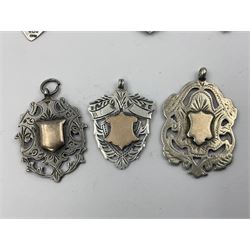 Seven Edwardian and later silver cartouche fobs, to include five gold faced examples and three double sided examples, all hallmarked with various dates and makers
