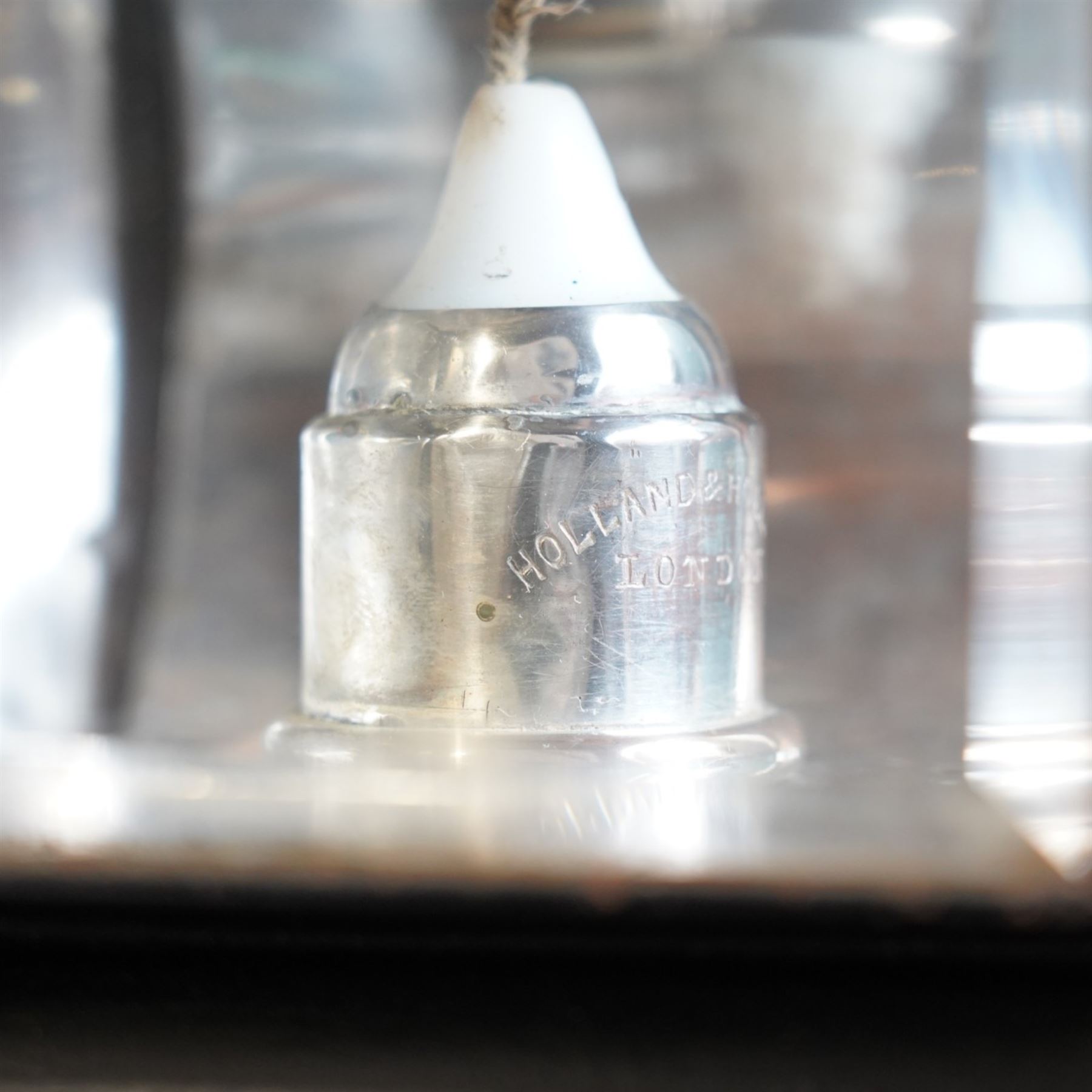 Holland & Holland (London) - pair of toleware and white metal carriage lamps, the traditional chimney over a rectangular form body with circular lens and rear red reverse light, maker engraved to candle mount