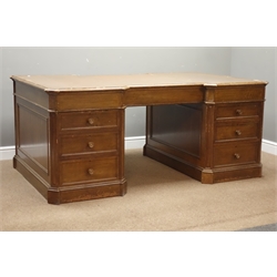  Large 20th century oak partners desk, canted and inverted break top inset with leather, five drawers to one side, two cupboard and three drawers to other, panelled sides, plinth base, W186cm, H79cm, D117cm  
