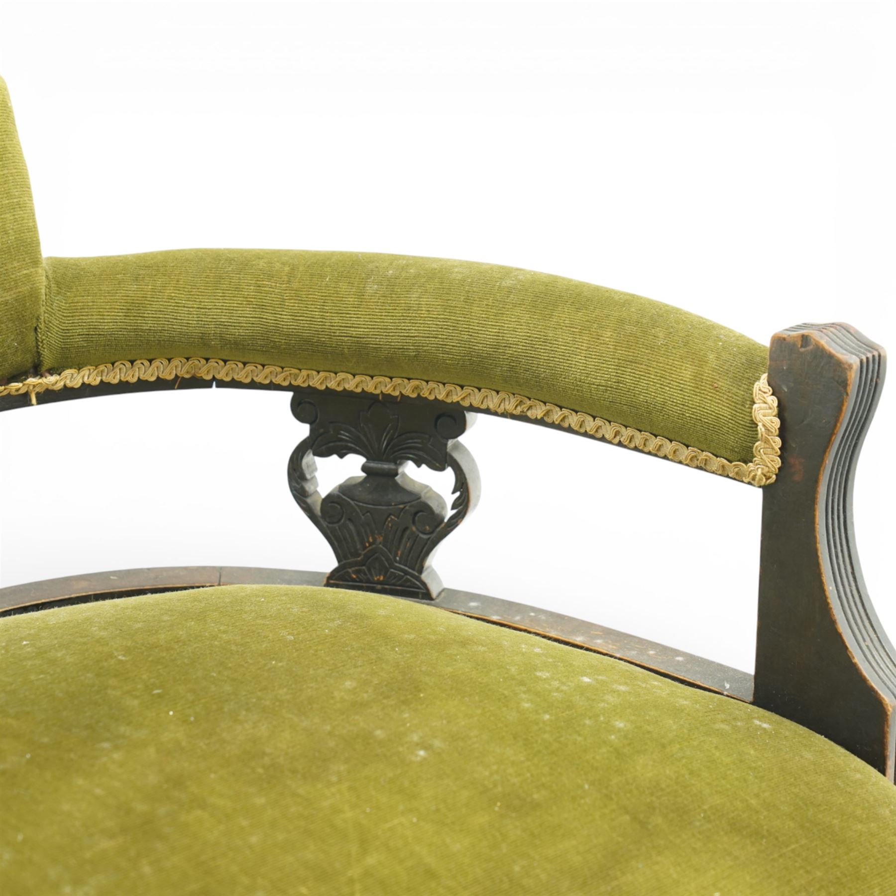 Late 19th century upholstered settee, shaped padded back with a row of button detailing, downswept open arms with upholstered pads, upholstered in olive green velvet, the frame with moulded rails and raised on turned front supports and out-swept rear legs with castors