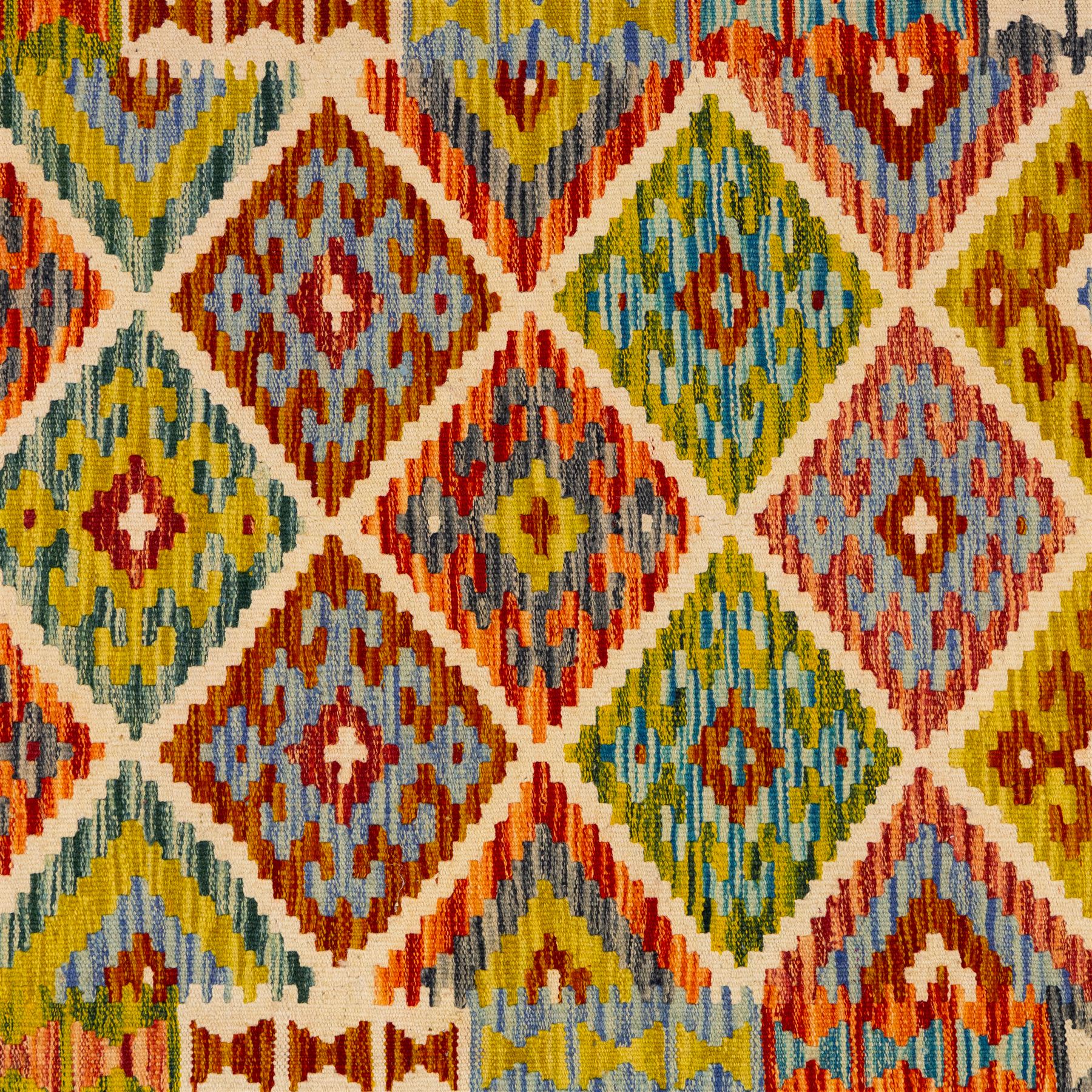 Turkish Anatolian flatweave kilim, ivory field decorated with rows of large stepped lozenge medallions enclosing stylized geometric motifs flanked by narrow geometric side panels, fringe ends 