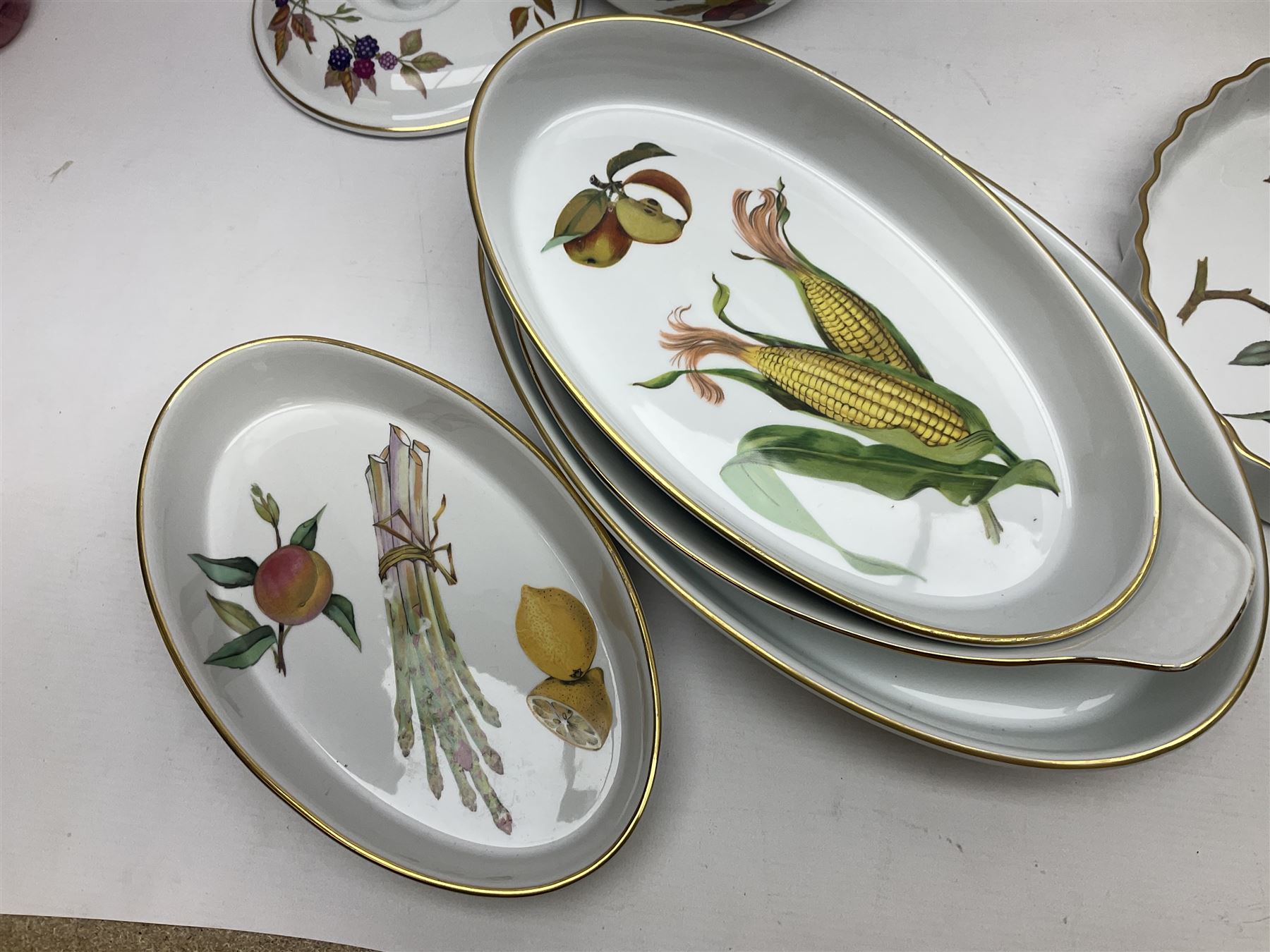 Royal Worcester Evesham pattern, including covered pot de cremes, twin handle tureen, serving dishes, flan dishes, side plates etc  