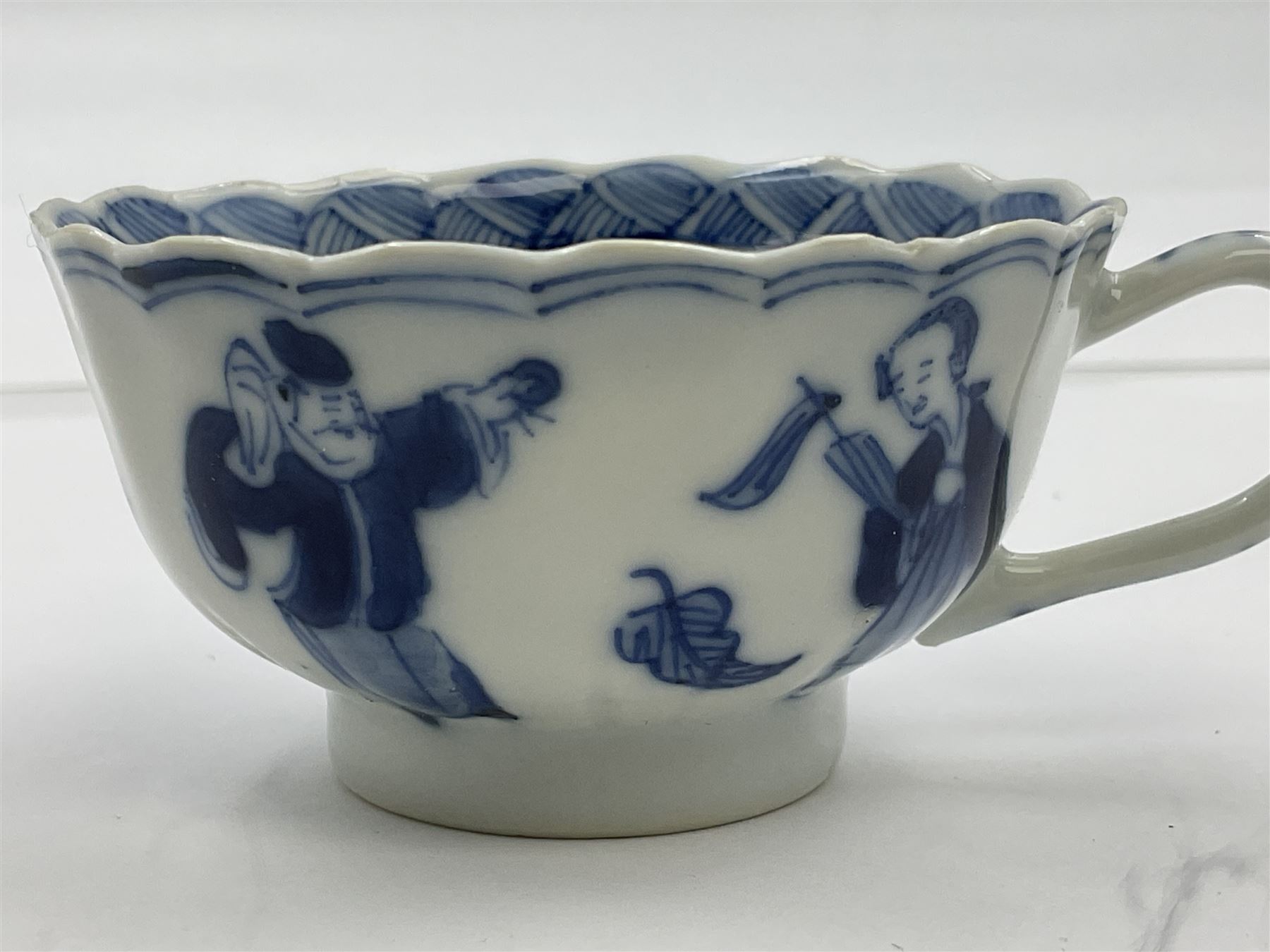 18th century Chinese blue and white Kangxi teacup and saucer, decorated with dancing figures, four character Kangxi mark beneath, saucer D10cm