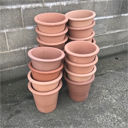 Twenty tapering terracotta pots, H31cm