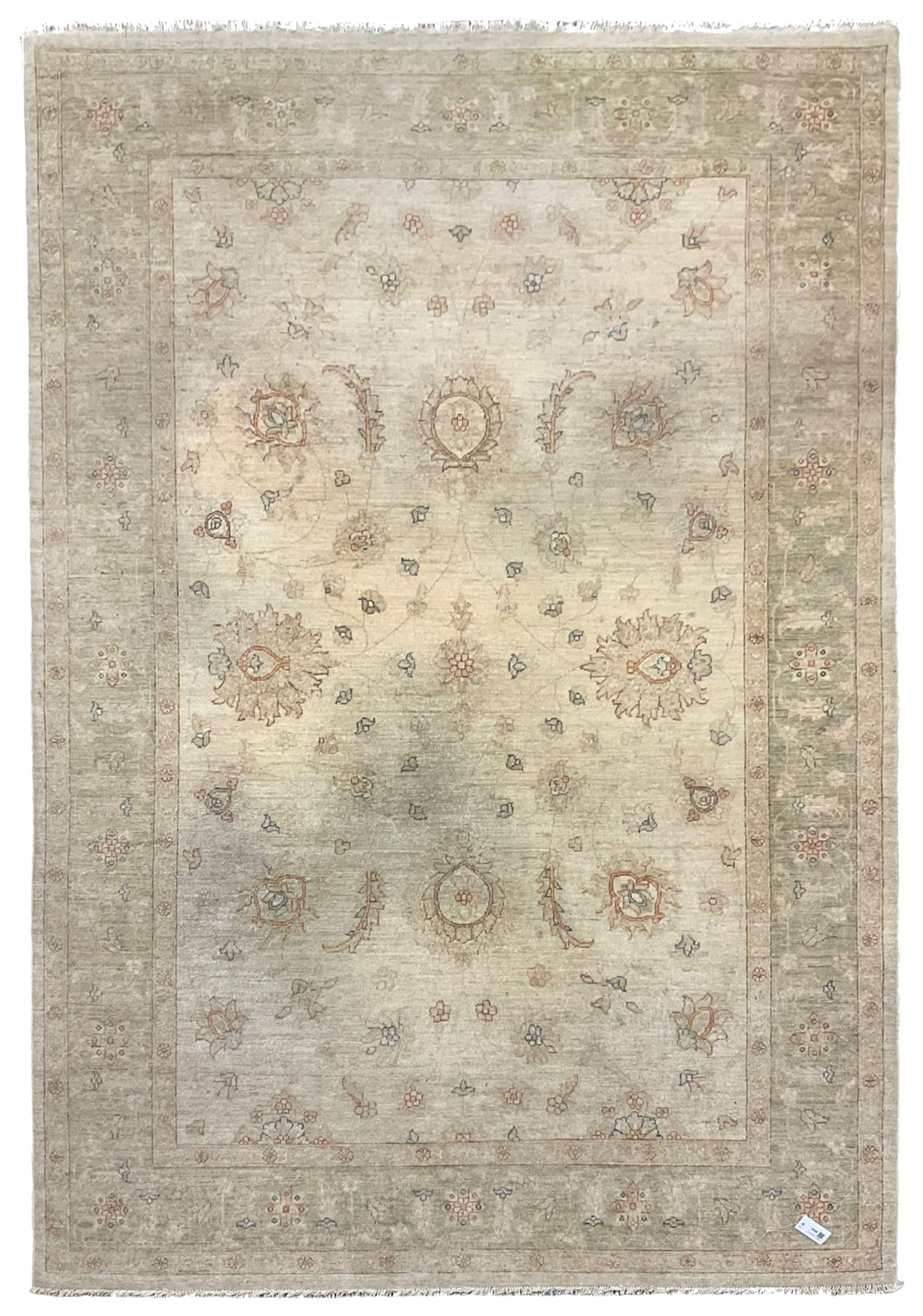 Persian Zeigler rug, ivory ground and decorated with stylised plant motifs, floral design border