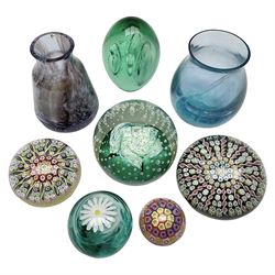 Three millefiori paperweights, together with a green glass dump paperweight with air bubble inclusions, Caithness Daisy and Cauldron paperweights and two small Caithness glass vases, tallest H9cm