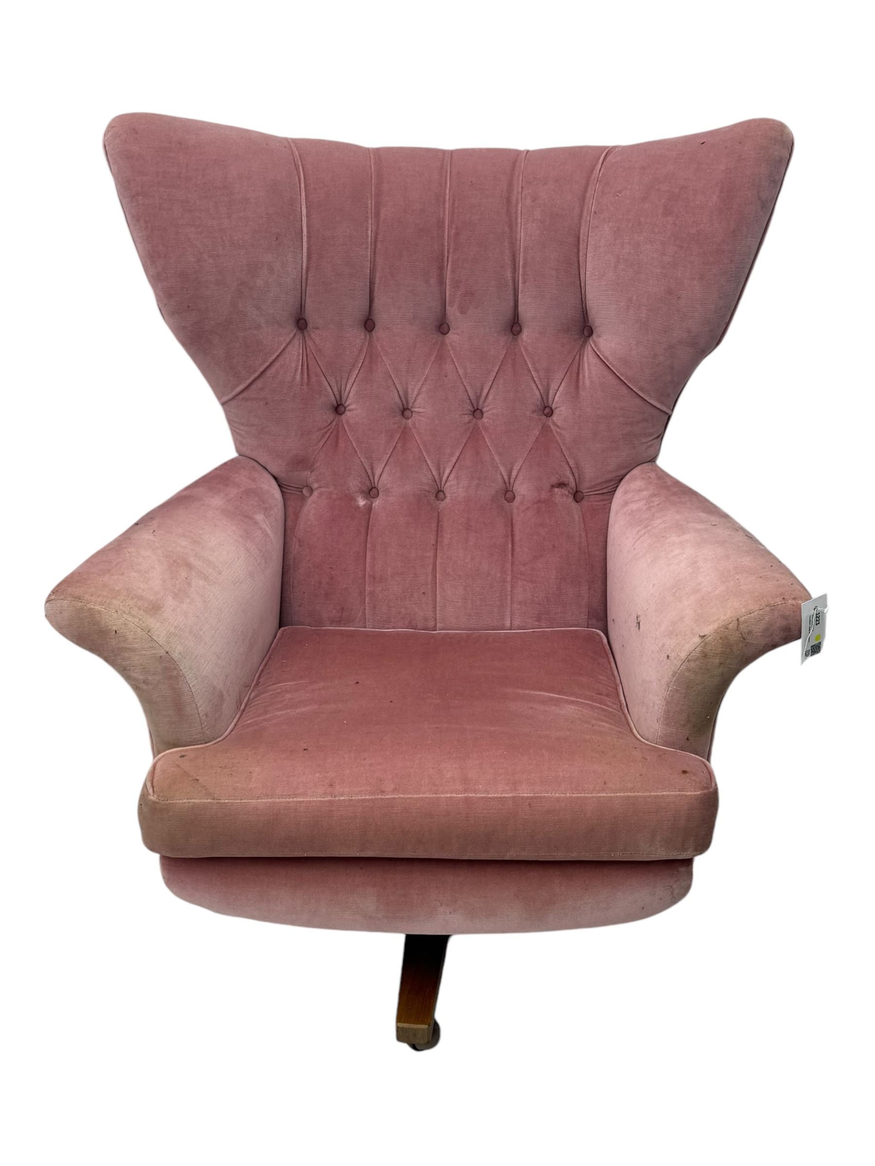 Paul Conti for G-Plan - 'Blofeld' Model 6250 swivel wingback armchair, upholstered in pink velour button back fabric, on teak base with castors