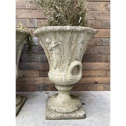 Set of four Victorian design cast stone Grecian urns, tapering form cast with figures and handles, square plinth bases