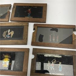Ten 19th century wooden framed glass animated magic lantern 'slipping' slides of comical figures and animals including one double action of Chinese acrobats L18cm (10)