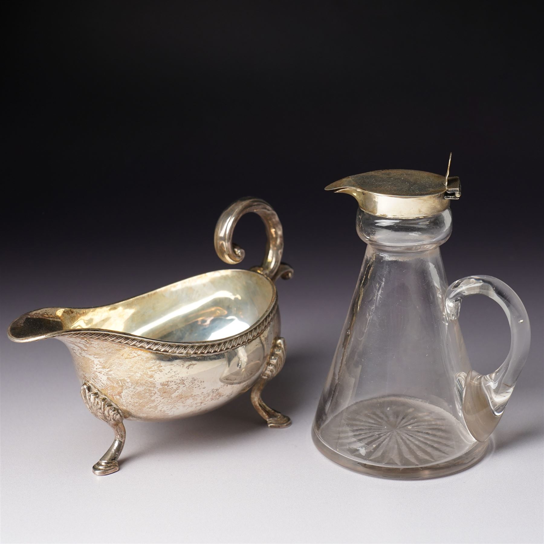 George V glass whisky noggin with hinged silver lid H10.5cm Birmingham  1912 and a silver sauce boat with C scroll handle Birmingham 1973 (2)