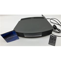 A Bose Wave music system, model AWRCC5, with remote control. 