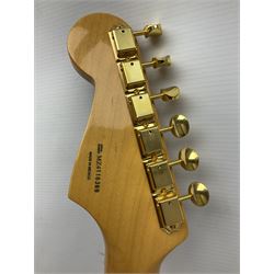 Fender Stratocaster 50th Anniversary 2004 metallic gold electric guitar; serial no.MZ4116369; L98cm; in Spider fitted case with owners manual and other paperwork, strap and belt buckle etc