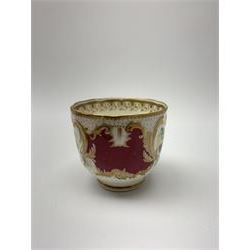 Early 19th century Minton coffee cup and saucer, decorated in pattern no 792, painted with landscape panels interspersed with claret panels and heightened throughout with gilt, cup H6cm, saucer D14.5cm

