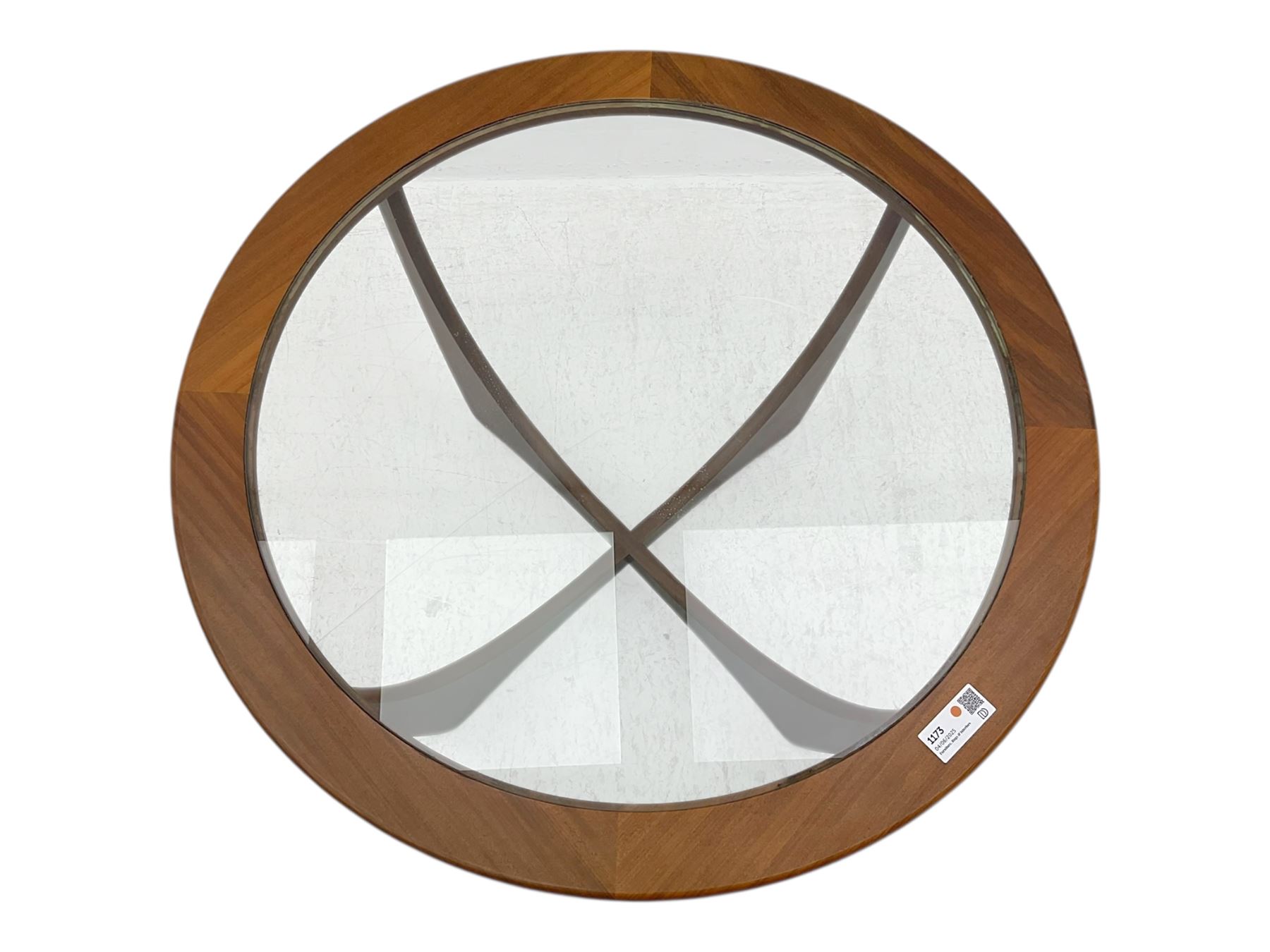 G Plan - Mid-century teak coffee table, circular form with inset glass top within a wide chamfered teak border, on sculptural cruciform base with curved intersecting supports