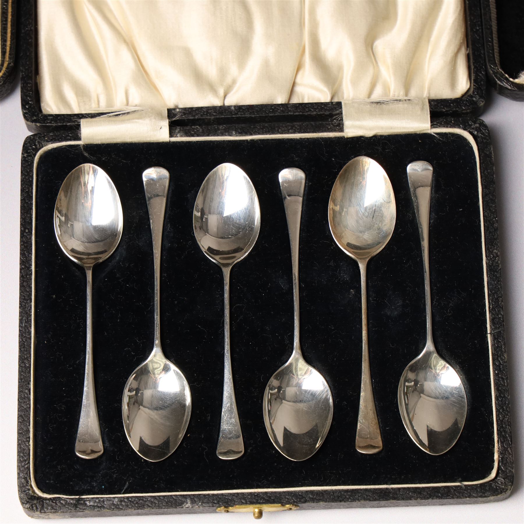 Set of six silver coffee spoons Birmingham 1933 , another set with bright cut stems and set of six silver handled pastry knives, all cased