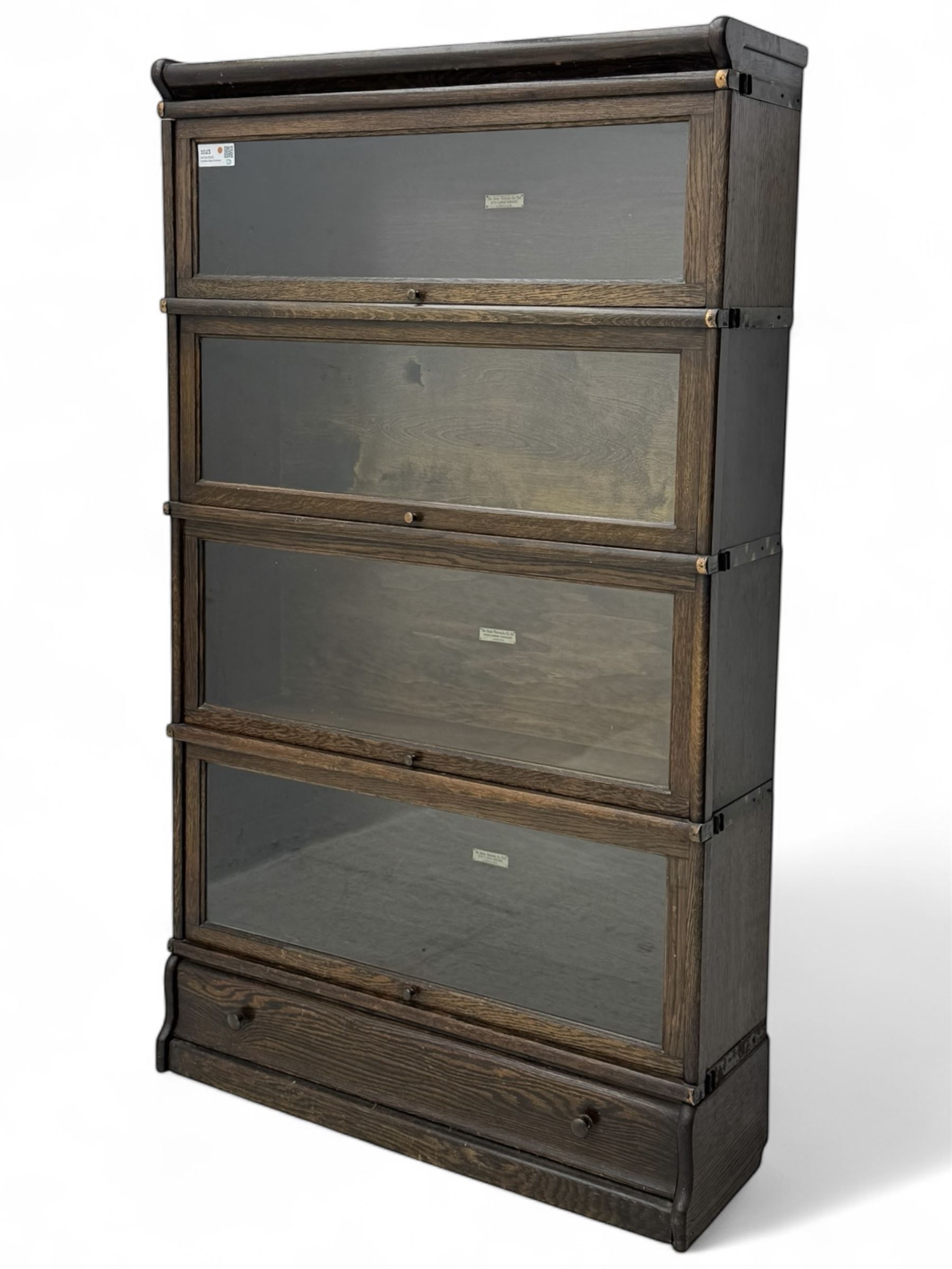 Globe Wernicke - stacking sectional library bookcase, over four glazed up-and-over doors, each bearing original makers mark, on moulded plinth base with inbuilt drawer