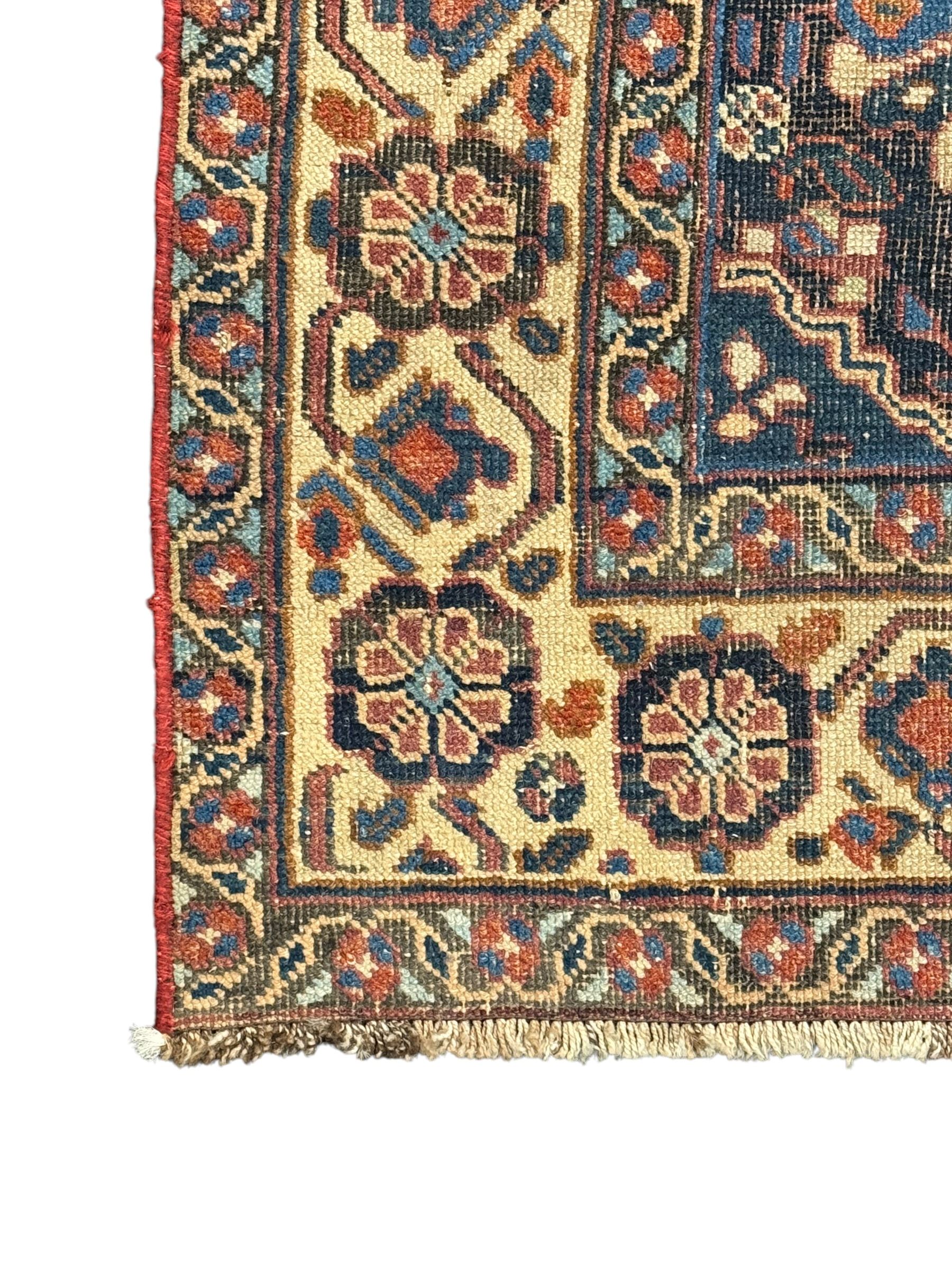 Caucasian pale ground rug, the field divided into lozenges each decorated with stylised plant motifs, the guarded border decorated with repeating flower heads 