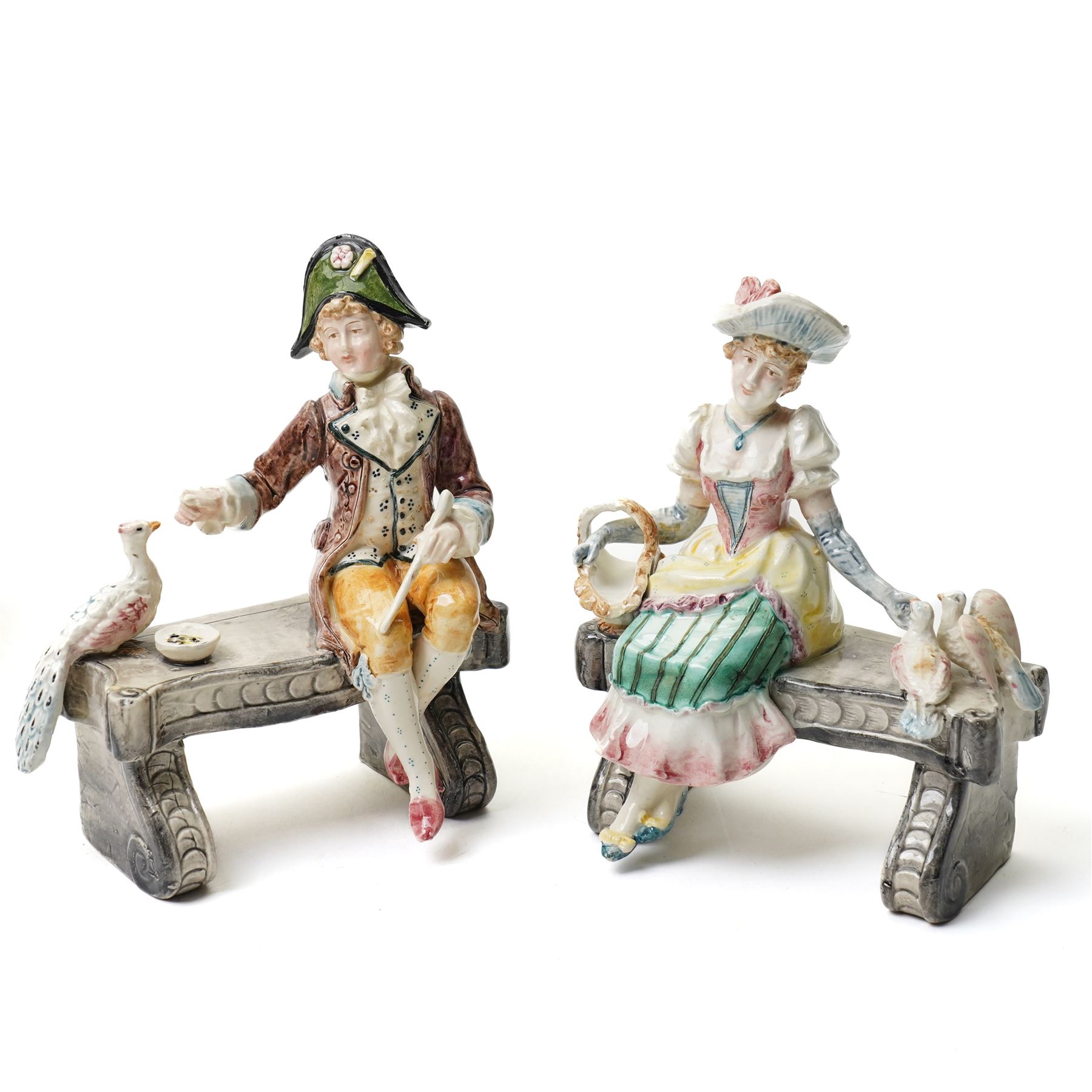 Collection of German and continental porcelain figures, including a figure of Juno with peacock, two figures feeding birds on benches, cherub candlesticks, and others