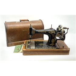 A cased Singer sewing machine, with instruction booklet and key. 